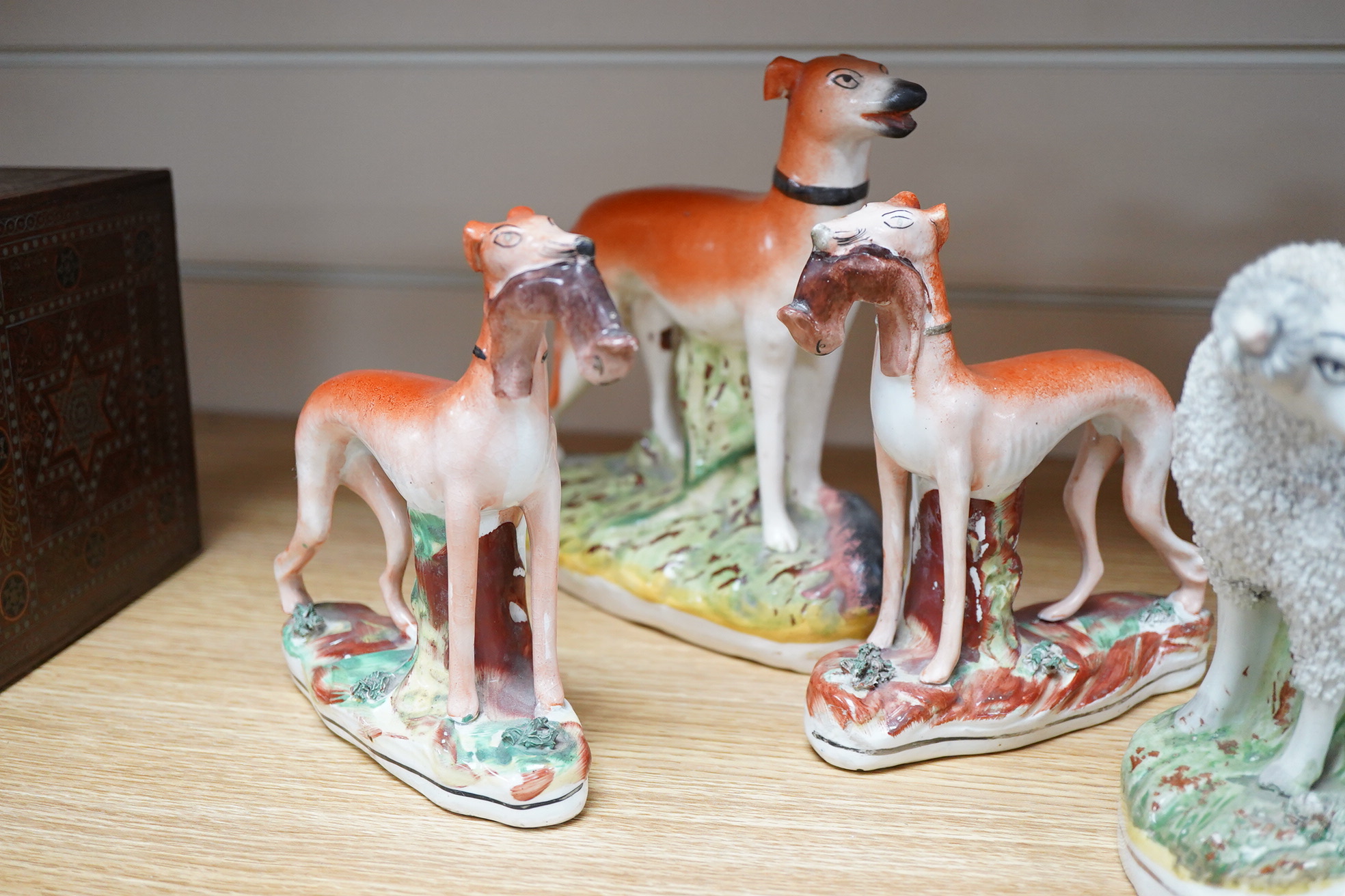Two pairs of Victorian Staffordshire zebra models and others to include three sheep spill vases, largest 19cm high
